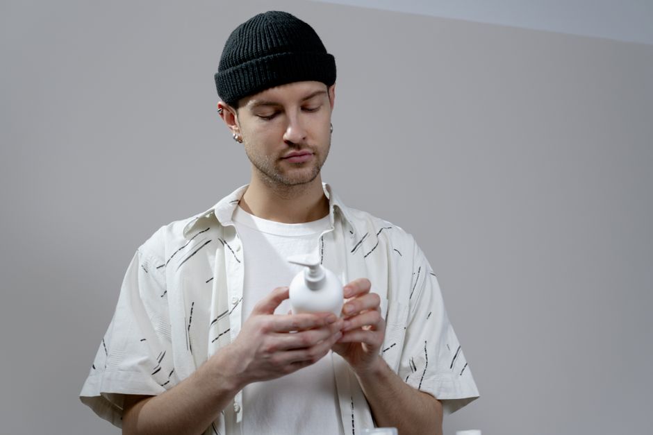 Man applying a light moisturizer to his face