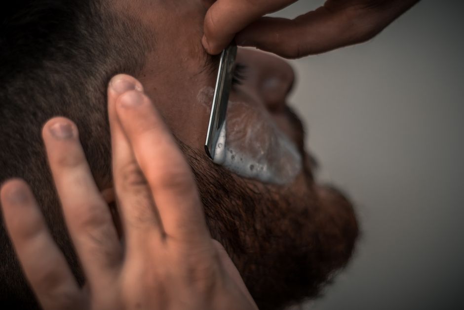 Man trimming his beard with an electric trimmer