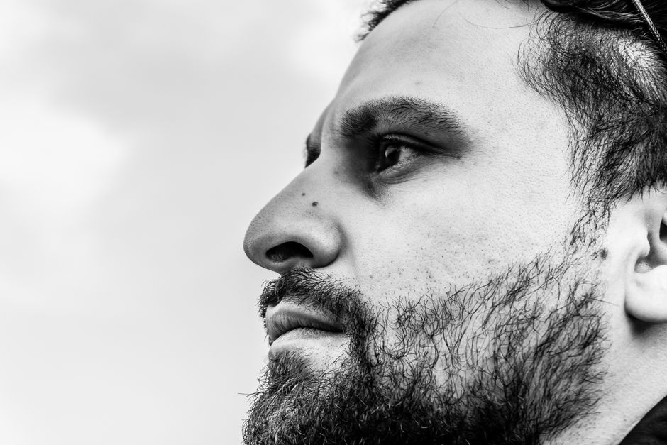 Side profile of a man with a groomed beard and clean neckline